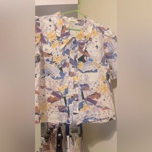 Nice top with purple and yellow white color size Medium